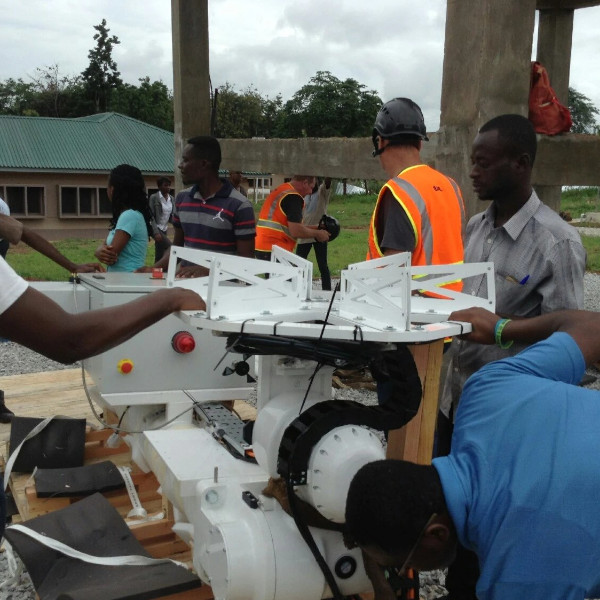 Engineers assembling a satellite ground-station antenna system